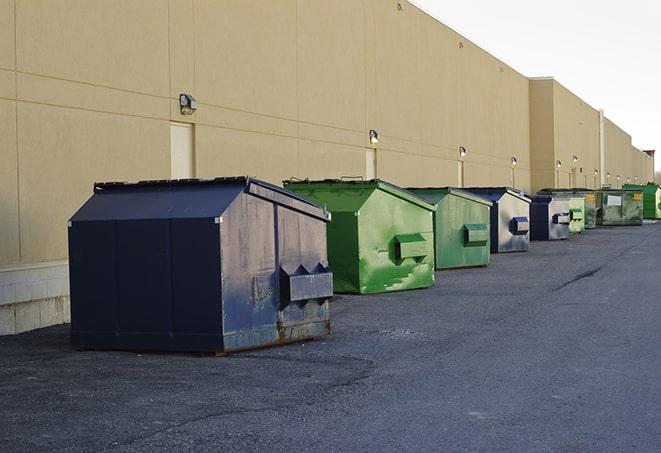 an assortment of sturdy and reliable waste containers near a construction area in Buzzards Bay